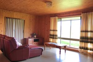 a living room with a couch and a table at Willunga Farm Retreat in Willunga