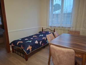 a dining room with a table and a table and chairs at Melkonyan's home in Gyumri