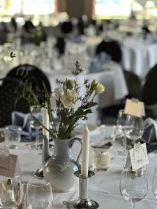 a table with a vase with flowers in it at Billum Kro in Billum