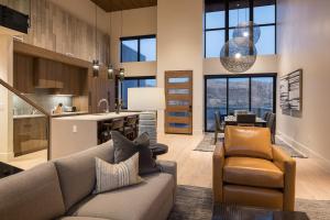 a living room with a couch and a kitchen at LIONSBACK RESORT in Moab