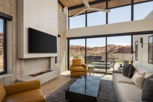 a living room with a couch and a fireplace at LIONSBACK RESORT in Moab