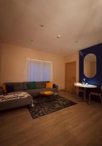 a living room with a couch and a table at Maison RoHa - B&B & Wellness in Dinant