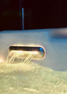 a glass bottle with water pouring out of it at Maison RoHa - B&B & Wellness in Dinant +13 photos
