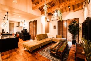 a living room with a couch and a table at The Villa Miyako in Hirara