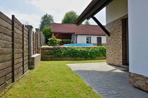 a backyard with a fence and a swimming pool at Chalupa u Zíků in Černá v Pošumaví