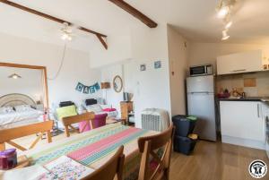 a kitchen and a dining room with a table and chairs at Framboisine in Cazères