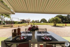 a table with wine glasses on it with a park in the background at Julia in Aussonne
