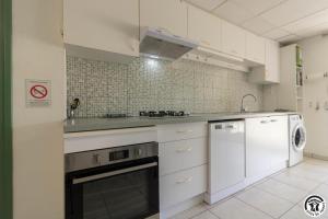 a kitchen with white cabinets and a dishwasher at Julia in Aussonne