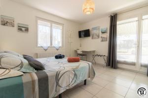 a bedroom with a bed and a desk in it at Julia in Aussonne