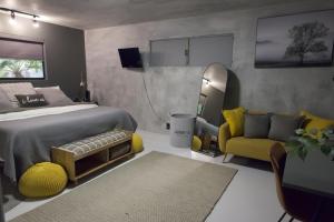 a bedroom with a bed and a chair and a mirror at Zion Base 3BR Home Backyard Oasis Pets Welcome in St. George