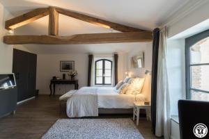 a bedroom with a large bed and a window at Le sourire des anges in Saint-Élix-le-Château +35 photos