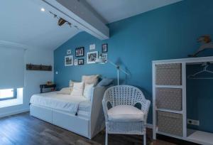 a blue bedroom with a bed and a chair at Le sourire des anges 2 in Saint-Élix-le-Château +28 photos