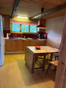 a kitchen with a wooden table with a bowl on it at Valhallsvägen 45 in Ängelholm