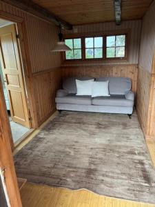 a couch in the inside of a tiny house at Valhallsvägen 45 in Ängelholm