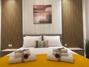 a bedroom with a large bed with towels on it at Ancient Philippi Luxury Apt MKP in Krinídhes