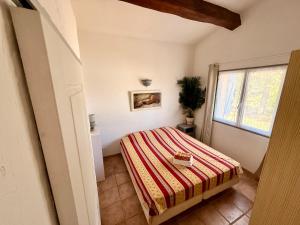 a bedroom with a bed and a window at Villa provençale La Banisté in Saint-Cézaire-sur-Siagne +54 photos