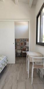 a room with a bed and a table and a bathroom at Andasì in Pachino