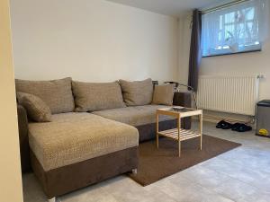 a living room with a couch and a table at Chambrette bei Kassel in Eiterhagen