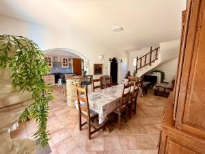 a kitchen and dining room with a table and chairs at Villa provençale La Banisté in Saint-Cézaire-sur-Siagne