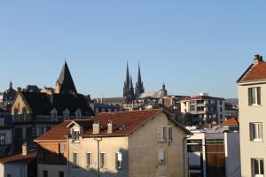 a large building with a clock on the top of it at Hôtel Beaulieu in Clermont-Ferrand
