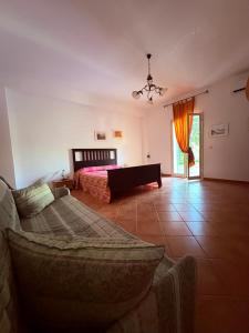 a living room with a bed and a couch at Ciuscia 0 in Calatabiano