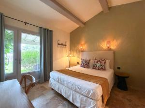 a bedroom with a large bed and a window at Hotel Mas Des Barres in Saintes-Maries-de-la-Mer +116 photos