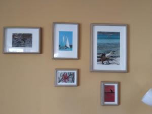 a group of pictures on a wall at Perfect View House in Sotír