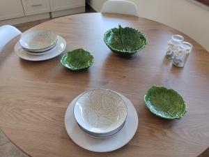 a wooden table with plates and bowls on it at Perfect View House in Sotír +21 photos