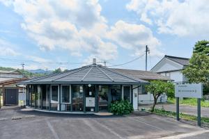 a building with a sign in front of it at Suikomareso 2 水処稀荘 三隈川別館 in Hita