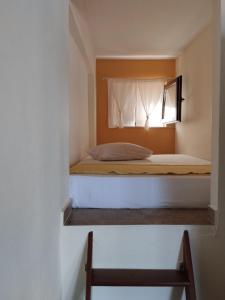 a bed in a small room with a window at Perfect View House in Sotír