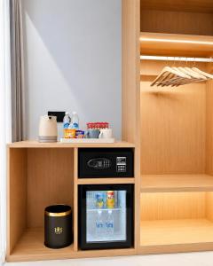 a kitchen with a small refrigerator and a shelf at H&H Boutique Hotel in Cukai