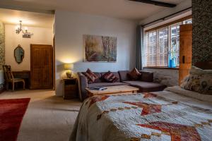 a living room with a bed and a couch at Ty Mawr, Brechfa in Carmarthen