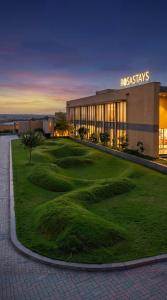 a resort with a golf course in front of a building at Rosastays Kutch in Tuna