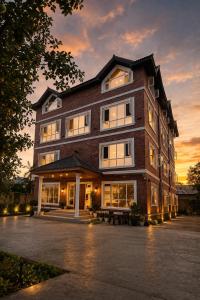a large brick building with a bench in front of it at Haven Retreat in Srinagar