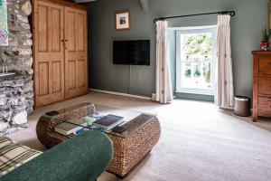 a living room with a couch and a coffee table at Ty Mawr, Brechfa in Carmarthen