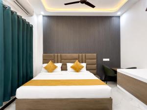 a bedroom with a bed with green curtains at Hotel Royal Awadh Near Shree Ram Mandir Ayodhya in Ayodhya