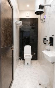 a bathroom with a toilet and a sink at Hotel Royal Awadh Near Shree Ram Mandir Ayodhya in Ayodhya +24 photos