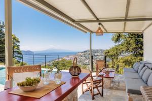 a dining room with a view of the ocean at Villa Theofilos in Glossa