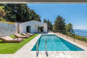a villa with a swimming pool and a house at Villa Theofilos in Glossa
