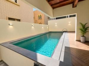 a swimming pool in the middle of a house at Soho Residence سوهو ريزيدنس in Kuwait