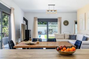 a living room with a table and a couch at Villa Theofilos in Glossa