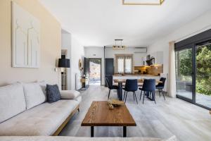 a living room with a couch and a table at Villa Theofilos in Glossa