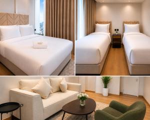 a hotel room with two beds and a couch at Soho Residence سوهو ريزيدنس in Kuwait