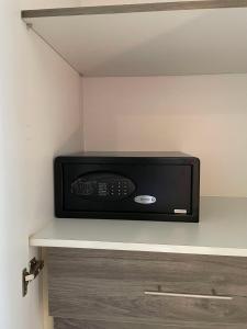 a microwave oven sitting on top of a shelf at Green Field Resort Hotel in Anda