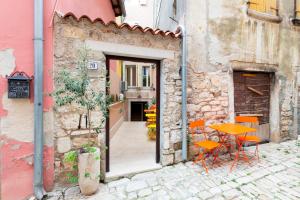 a table and chairs sitting outside of a building at Villa NEA Seaview! Deluxe apartments in old town! in Rovinj