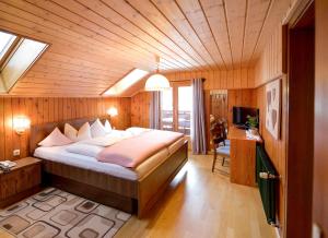 a bedroom with a large bed in a wooden room at Chalet Sonne Vandans in Vandans