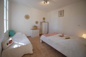 a bedroom with two beds and a refrigerator at Sélection Camping La Croix -Valmer in La Croix-Valmer +15 photos