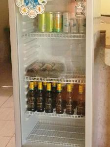 a refrigerator filled with lots of bottles of beer at Oundo LVHAR in Busia