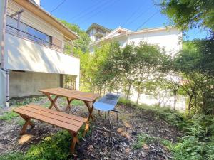 a picnic table and a chair next to a building at トラストメゾン西伊豆 in Ukusu +13 photos