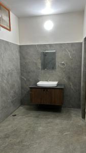 a bathroom with a sink and a mirror at Kosala grand in Bhadrāchalam +24 photos